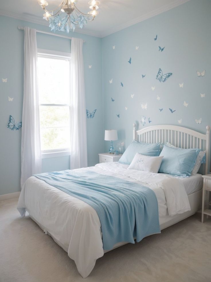 a bedroom decorated in blue and white with butterflies on the wall