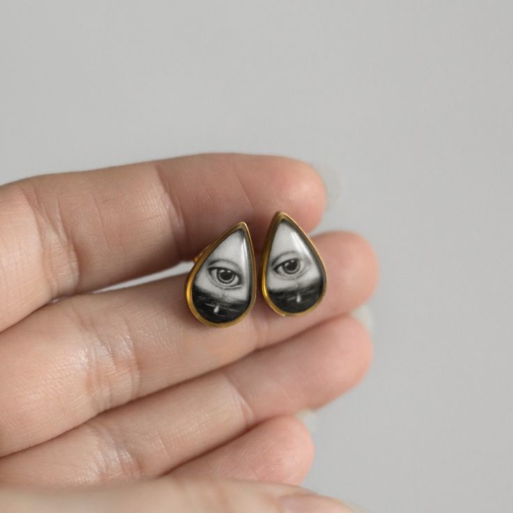 Small Victorian Gothic earrings with crying lover's eye. Illustration are printing. The earring is made of brass (frame), gold color, epoxy resin, surgical steel (stud) Frame with illustration: 10x16 mm The illustration is fixed with a thick layer of colorless epoxy resin. The resin is a protruding smooth dome. I need the maximum amount of time to prepare the earrings - 9 business days. Gift Black Enamel Stainless Steel Jewelry, Surgical Steel Drop Earrings For Gift, Surgical Steel Drop Earrings As Gift, Teardrop Stainless Steel Earrings For Gifts, Stainless Steel Teardrop Earrings For Gift, Black Surgical Steel Earrings For Gift, Black Enamel Teardrop Earrings For Gift, Teardrop Black Enamel Earrings For Gift, Teardrop Enamel Earrings For Gifts