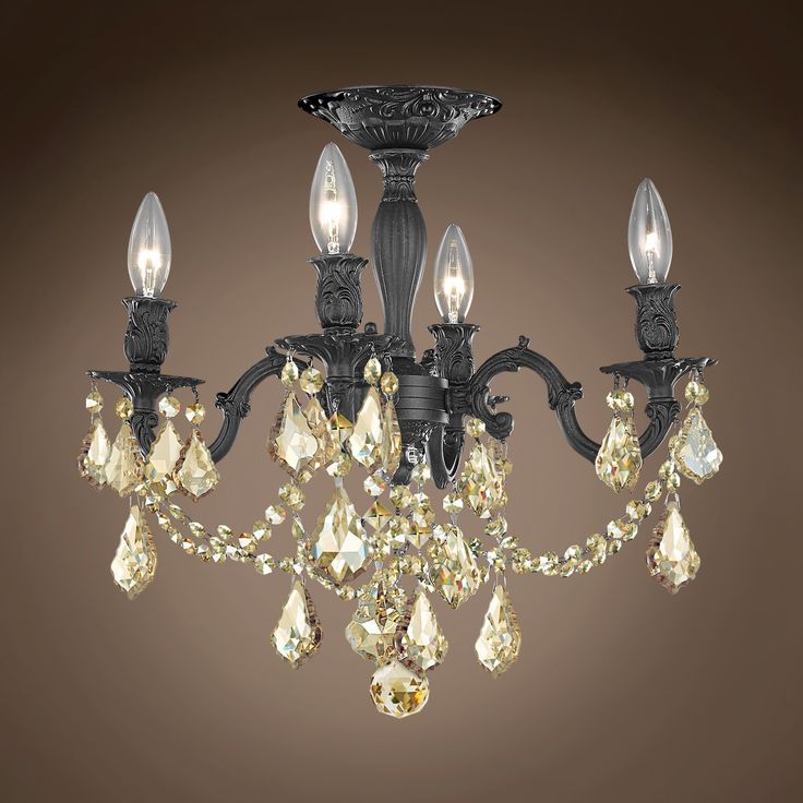 a chandelier with crystal drops hanging from it's sides and two lights on each side