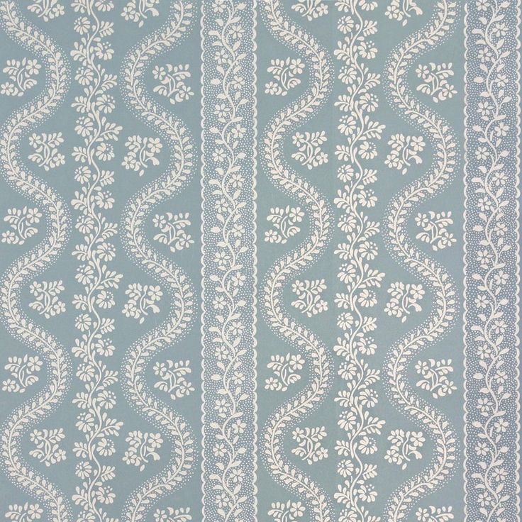 a blue and white wallpaper with an intricate design on it's side,