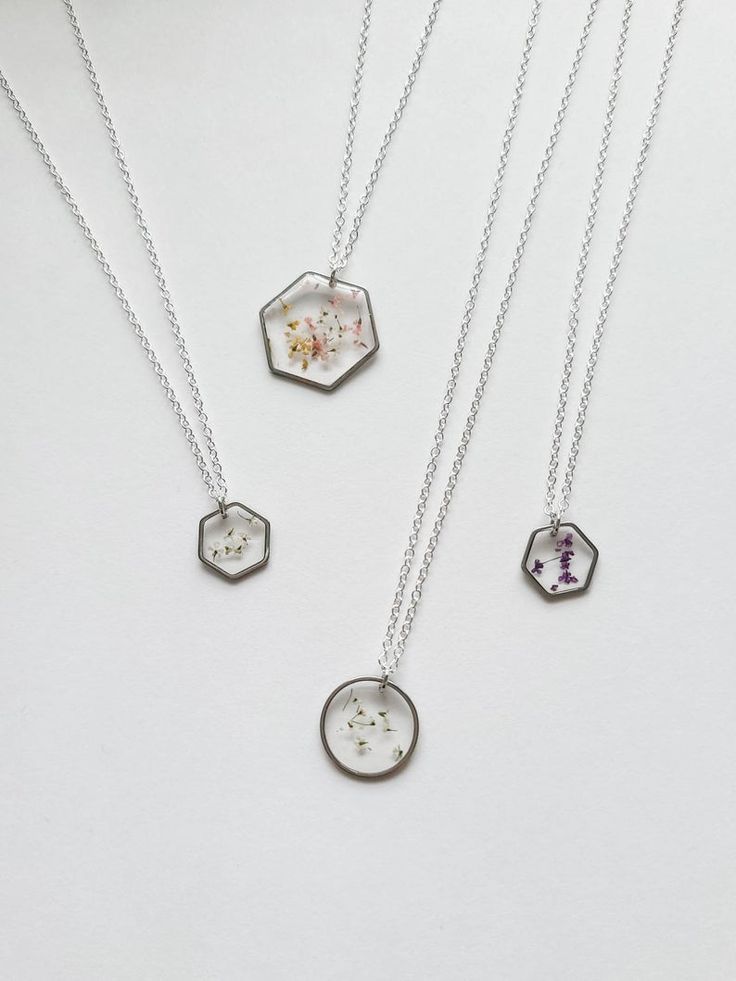 three necklaces with different designs on them