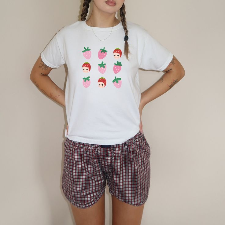 Strawberry Sonny Angel. Revamp your wardrobe with Everlace Designs' exclusive collection of essential tees, cozy hoodies, and playful baby tees in signature prints. Shop now for vibrant, cheeky designs perfect for any casual occasion. Elevate your everyday style with Everlace! Disclaimer: Product Images  Please note that the images displayed are digital mock-ups designed to give you a general idea of the style and design of our T-shirts. These images are intended for reference only and should no Casual Pink T-shirt For Pajama Party, Casual Cotton Sleepwear With Strawberry Print, Casual Graphic Print T-shirt For Pajama Party, Cute White Organic Cotton Tops, Playful Crew Neck T-shirt For Loungewear, Playful White Tops For Everyday, Playful Relaxed Fit Tops For Pajama Party, Cozy Cotton Everyday Tops, Cozy Everyday Cotton Tops