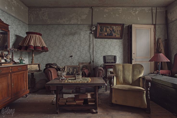 a living room filled with furniture and pictures on the wall next to a table in front of a window