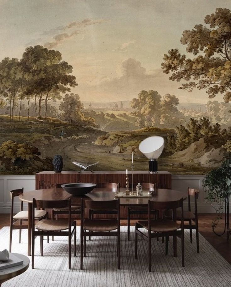 a dining room with a large painting on the wall