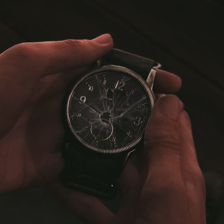 a person holding a watch in their hand