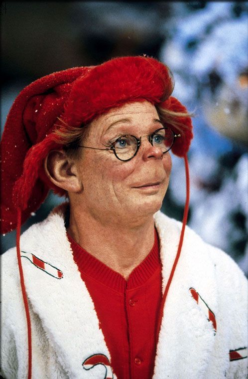 an old woman wearing glasses and a red hat