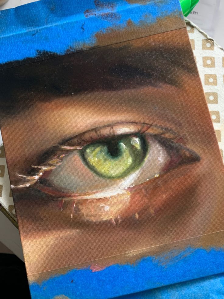 a painting of an eye with green eyeshade and blue paint on the paper