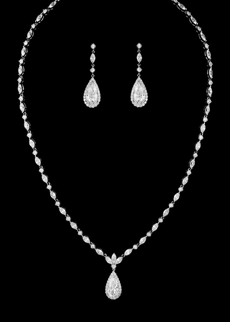 Teardrop CZ Wedding Jewelry SetThis sensational cubic zirconia necklace and matching pierced earring set will be the perfect accessory to complete your elegant wedding day look. This beautiful jewelry set, available in silver or gold plating, features a chain of brilliant round and marquise cut cz crystals with a center decoration of a larger teardrop stone. The matching drop earrings echo this design.Size: Necklace is about 16" long. Pierced Earrings - about 1.5" long.Color: Silver or Gold.Styl Wedding Jewelry Set, Silver Jewellery Indian, Bling Wedding, Silver Jewelry Design, Engagement Rings Opal, Silver Jewellery Sets, Anniversary Jewelry, Jewelry Outfit, Wedding Jewelry Sets