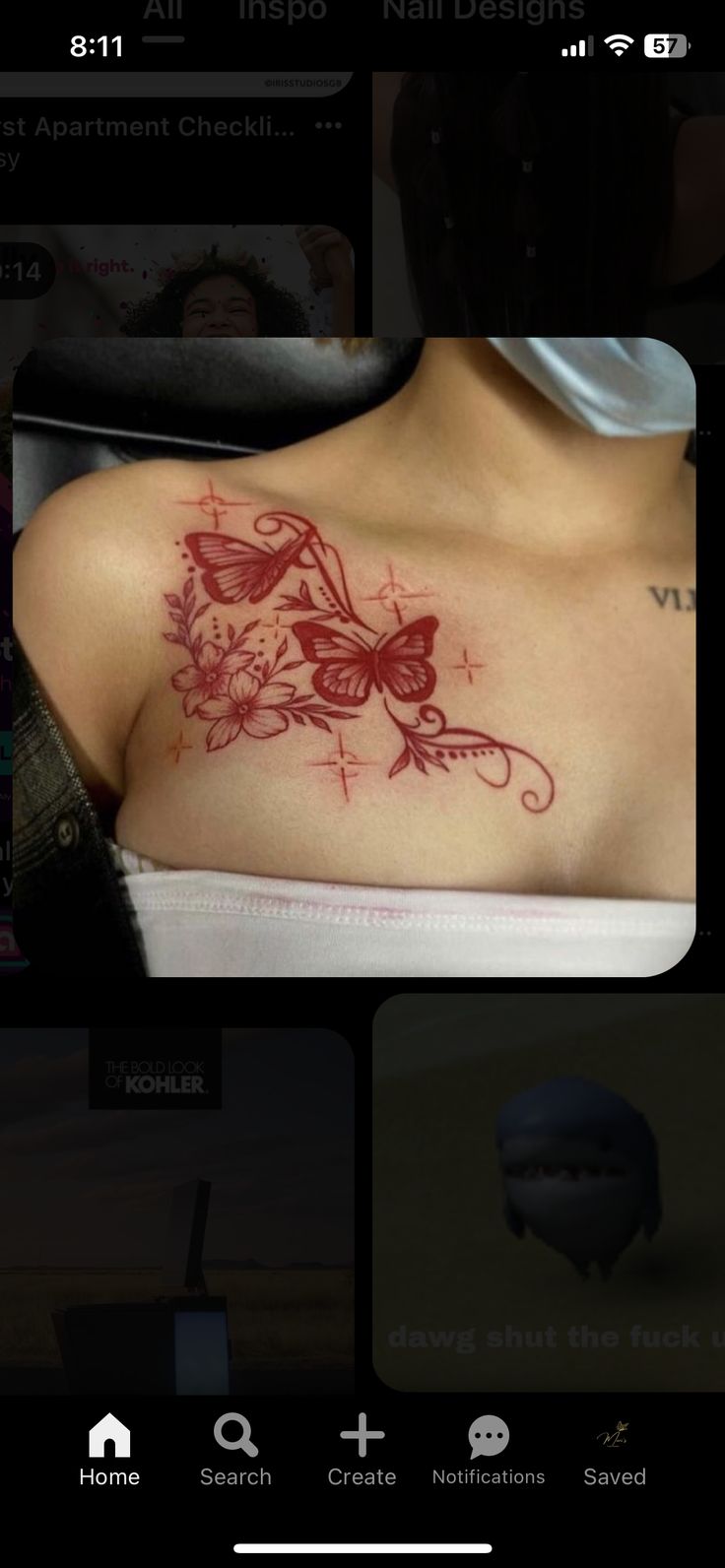 the back of a woman's shoulder with red ink on her chest and flowers