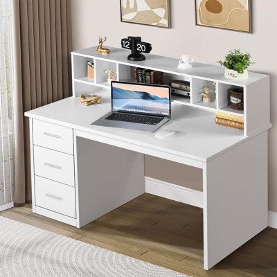 a white desk with a laptop on it in front of two pictures and a rug