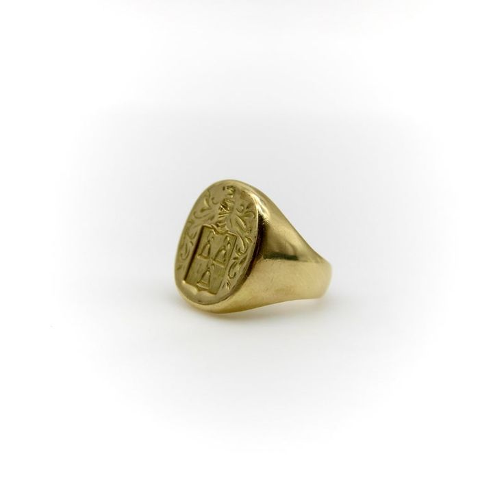 This 18k gold Tiffany & Co. Larter & Sons signet ring is hand carved with a heraldic family crest. The crest has a shield with three bell-like shapes sprouting flowers. Above the shield is a knight’s helmet topped with a feather and surrounded by scrolling foliate. The classic design of the crest suggests royalty and valor.  Larter & Sons was founded in 1865 and was renowned for their exquisite craftsmanship of men’s accessories. They expanded to include women’s jewelry in the early 20th century, using intricate techniques such as guilloche and enamelwork, and incorporating motifs inspired by nature. They collaborated with Tiffany & Co. to make jewelry such as cufflinks and signet rings. Tiffany & Co. would often consign well-known brands of the highest quality, including Larter & Sons. Classic Oval Signet Ring With Coat Of Arms, Classic Engraved Ceremonial Signet Ring, Classic Engraved Signet Ring For Ceremonial Occasions, Classic Engraved Signet Ring For Ceremonial Use, Classic Yellow Gold Engraved Ring With Coat Of Arms, Ceremonial Oval Signet Ring Stamped 14k, Formal Gold Signet Ring With Coat Of Arms, Heirloom Oval Signet Ring With Coat Of Arms, Formal Yellow Gold Engraved Ring With Coat Of Arms