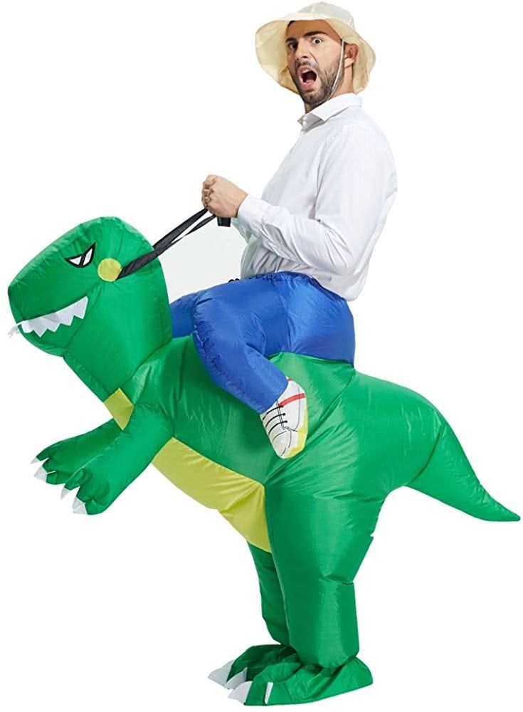 a man riding on the back of an inflatable t - rexe costume