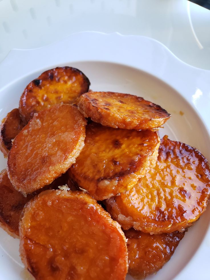 some fried bananas are on a white plate