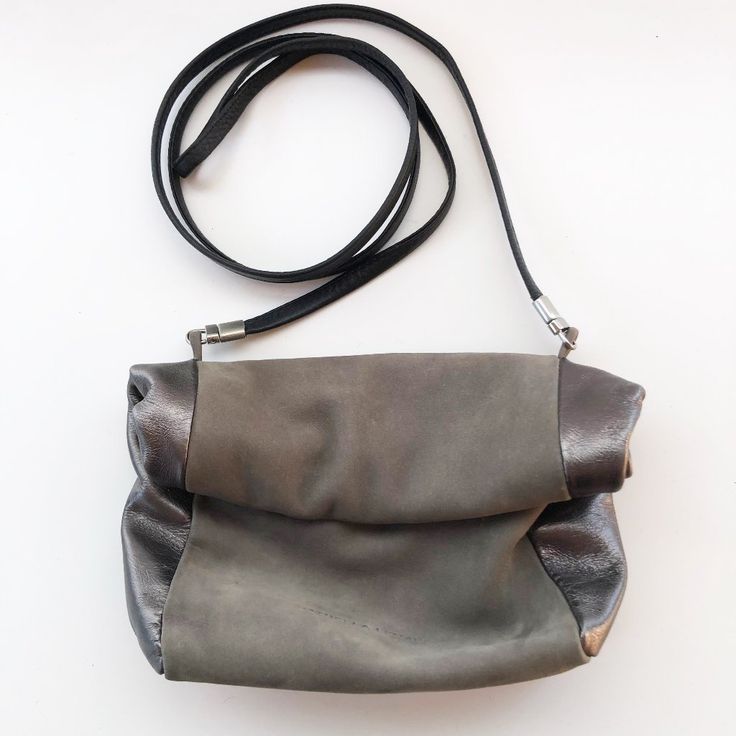 Unique And Oh So Chic! Designed And Handmade By Daniella Lehavi, Israel. Sold At Anthropologie. Minimalist Crossbody Mini Roll Top Bag. Remove The Strap To Use As A Clutch. Grey Suede And Gunmetal Metallic Leather. Open Top Rolls Down And Holds In Place With Magnets. Love The Design Of This Gorgeous And Understated Bag. Excellent Condition Used Gently, Only Once. Measures Approx: 7w X 6.5h X 3d Smoke / Pet Free Home. Leather Flap Bag With Gunmetal Hardware For Evening, Silver Shoulder Clutch For Everyday Use, Evening Crossbody Flap Bag With Gunmetal Hardware, Silver Leather Clutch Shoulder Bag, Silver Clutch With Detachable Strap For Everyday Use, Leather Evening Bag With Magnetic Closure, Daily Use Crossbody Clutch With Magnetic Closure, Silver Leather Clutch Evening Bag, Everyday Leather Clutch With Fold Over Clasp