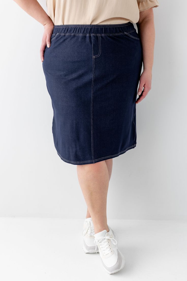 With the look of real denim but the feel of a quality knit, comfort is the key element in our exclusively designed 'Piper 'Skirt. The quick, pull on style with a fabric covered waistband makes this skirt a practical everyday option! Soft, comfortable knit denim fabric Functional Back Pockets 70% Rayon 25% Polyester 5% Spandex Wash Cold Gentle Cycle Hang to Dry Fabric covered elastic waistband Model A Height in Dark Blue 5'5" | Wearing Size Small Wearing 'Finch' Smocked Yoke Cotton Gingham Top in Casual Dark Wash Knee-length Denim Skirt, Knee-length Lined Denim Skirt, Relaxed Knee-length Denim Skirt With Pockets, Stretch Cotton Denim Skirt Knee-length, Knee-length Dark Wash Cotton Denim Skirt, Gingham Top, Gingham Tops, Knit Denim, Knit Skirt