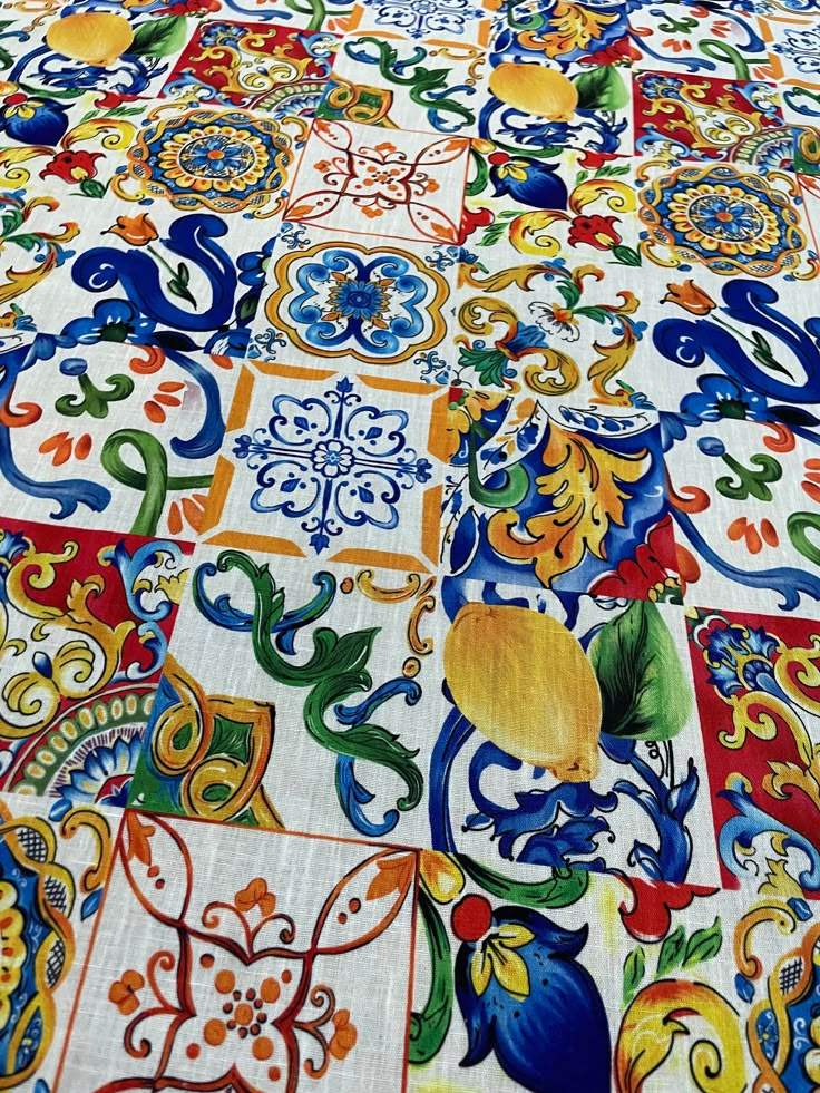 a colorful table cloth with many designs on it