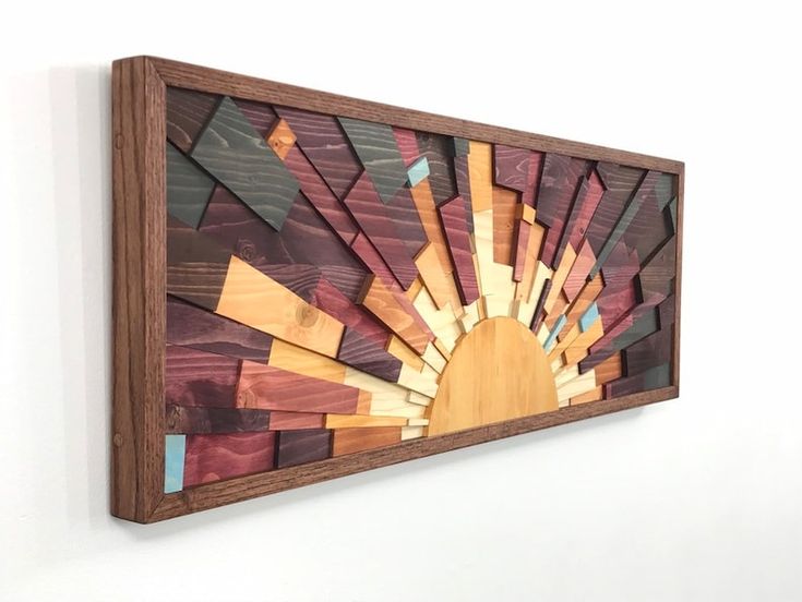 a wooden wall hanging on the side of a white wall