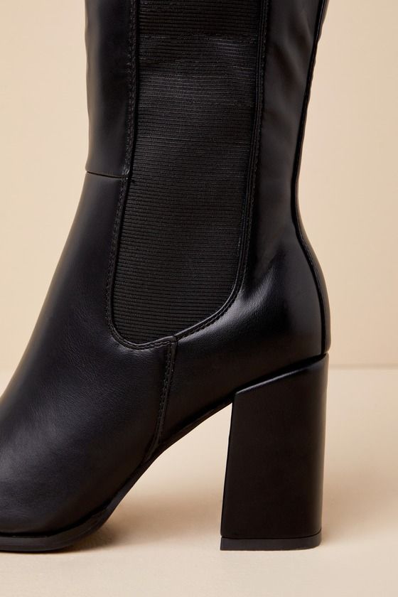 Every look you create with the Thia Black Square Toe Knee-High Boots will be worth everyone's attention! Sleek faux leather shapes these perfectly chic boots that feature a trendy square-toe upper that rises to a 13.5"" knee-high shaft with an elastic gusset along the outstep, a 15.25"" zipper at the instep, and a convenient pull tag at the bag. 14"" circumference. A sturdy block heel completes the stylish design! Available in whole sizes only. 3. 25" wrapped block heel. Lightly cushioned insole Trendy Faux Leather Heeled Boots With Reinforced Heel, Chic Square Toe Chelsea Boots For Winter, Trendy Faux Leather Block Heel Boots, Chic Fitted Chelsea Boots With Square Toe, Sleek Faux Leather Mid-calf Boots For Fall, Elegant Fitted Heeled Boots In Polyurethane, Elegant Fitted Polyurethane Heeled Boots, Elegant High Heel Knee-high Boots, Elegant Fitted Chelsea Boots With Square Toe