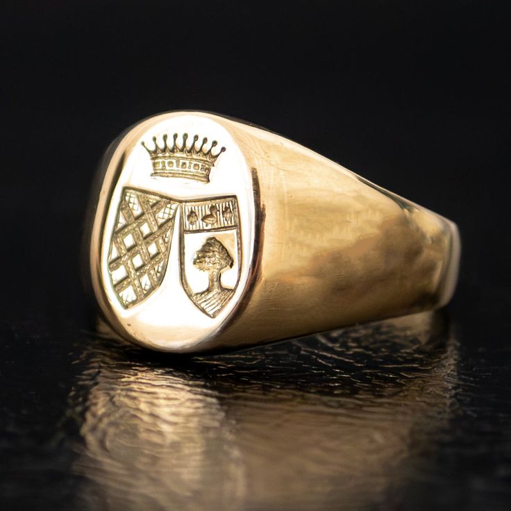 A regal engraving of two crests beneath a crown adorns the signet of this unique vintage ring. Substantial and prestigious, this ring feels both historic and fashion-forward. The thick band tapers in the back for an everyday comfortable fit. Metal: 18k Yellow GoldMeasurements: Width: 12-2mm Size 6.25 in stock Shipping and Delivery: IN STOCK items will ship within 2 business days Sizes not In Stock will be Resized Resize Fee may apply Please allow 2 weeks for delivery All Resize items are final s Classic Ceremonial Signet Ring With Polished Finish, Classic Engraved Signet Ring For Ceremonial Occasions, Classic Engraved Signet Ring For Ceremonial Use, Classic Engraved Ceremonial Signet Ring, Classic 14k Gold Signet Ring For Ceremonial Occasions, Classic Engraved Rings For Ceremonial Occasion, Classic Oval Ceremonial Signet Ring, Classic Engraved Rings For Ceremonies, Classic Ceremonial Engraved Rings