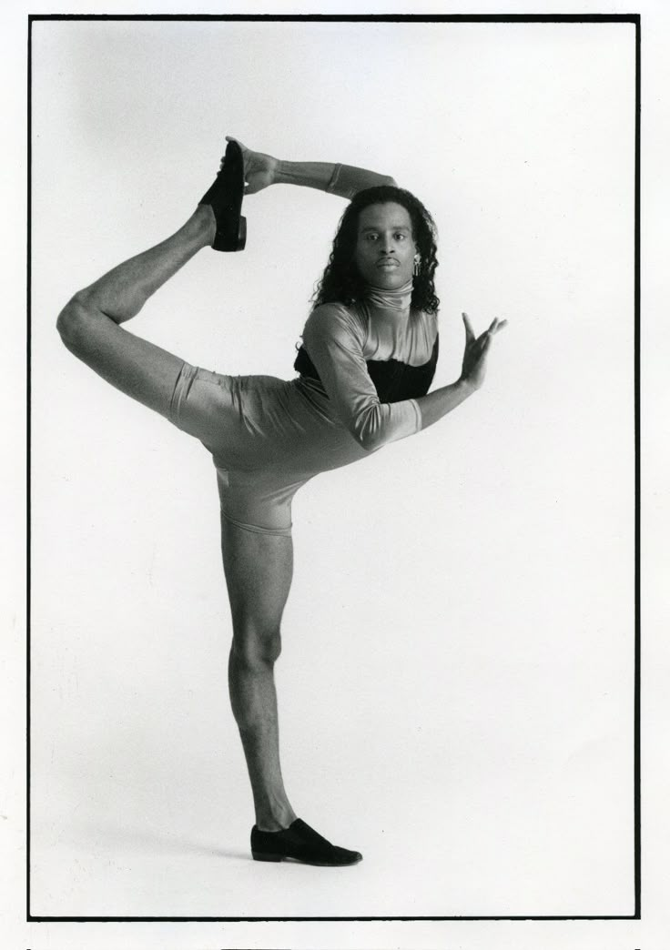 a woman in tights is doing a yoga pose