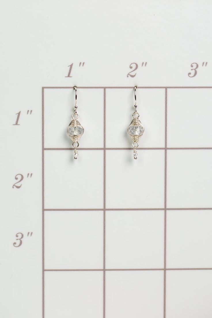 A beautiful gift for those born in April, featuring their birthstone of stunning quartz that is hand wrapped in sterling silver wire. These feminine earrings dangle from sterling silver earwires. Sterling Silver (lead and nickel free) Quartz .75", on sterling silver earwires We hand select our natural materials, thus there may be slight variations in color and/or size that will not detract from the overall aesthetic Our unique handcrafted designer jewelry for women is made in America, with each Sterling Silver Wire Wrapped Crystal Earrings, Nickel Free Silver Teardrop Wrap Earrings, Sterling Silver Wire-wrapped Crystal Drop Earrings, Nickel-free Silver Teardrop Wrap Earrings, Silver Nickel-free Teardrop Wrap Earrings, Everyday Silver Dangle Crystal Earrings, Silver Wire Wrapped Drop Earrings, Hypoallergenic Silver Wrap Earrings In Sterling Silver, Silver Crystal Earrings With Ear Wire For Everyday