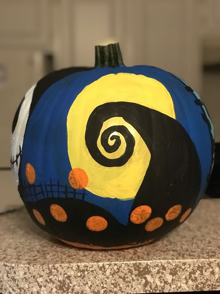 a painted pumpkin sitting on top of a counter