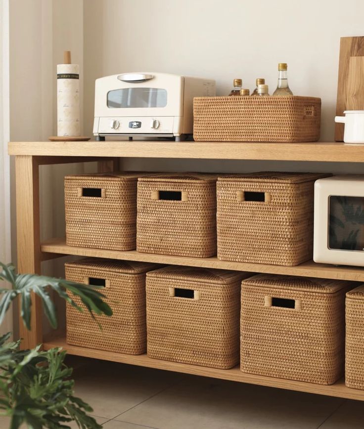 a shelf with baskets and microwave on it