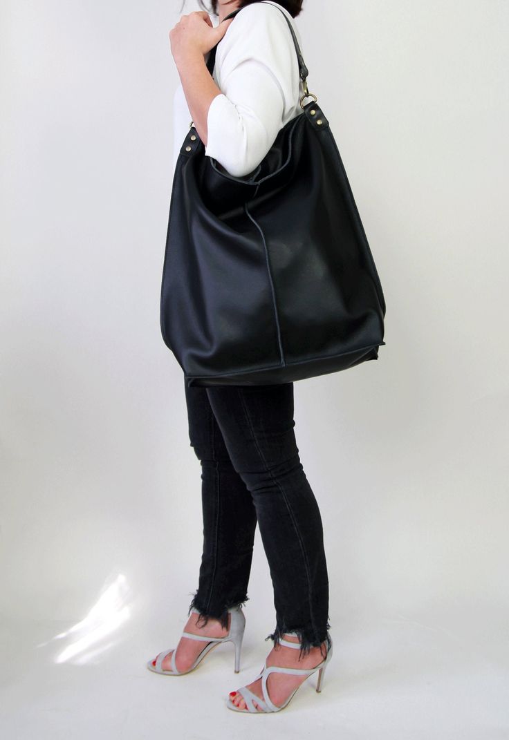 Black leather hobo This black large tote bag is made from high quality italian leather. Spacious interior provides room for all the daily essentials and more. There is an inside zippered pocket. This bag is perfect as your everyday bag, which can fit an IPAD, laptop, A4 files, books, magazines, cosmetic bag as well as many accessories. This bag has top zipper closure for safety. Height: 18,5 inch (47 cm) Width: 18,1 inch (46 cm) Length of handle: 19,3 inch (49 cm) Bottom width: 13,4x 5,5 inch (3 Black Hobo Bucket Bag For Shopping, Black Hobo Bag With Leather Handles For Errands, Black Hobo Satchel For Errands, Versatile Black Hobo Bag, Everyday Large Capacity Black Hobo Bag, Black Soft Leather Hobo Shoulder Bag, Everyday Black Hobo Bag, Black Hobo Bag With Large Capacity, Black Hobo Bag With Removable Pouch