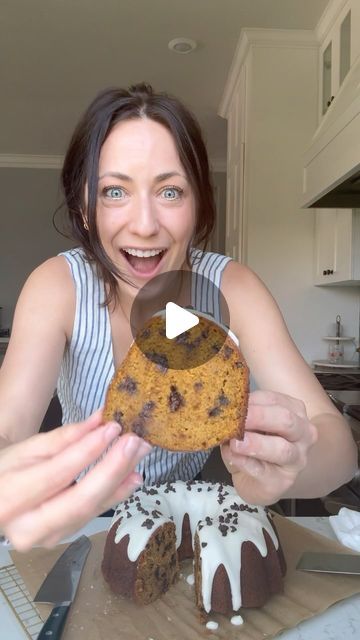 a woman holding up a chocolate chip cookie