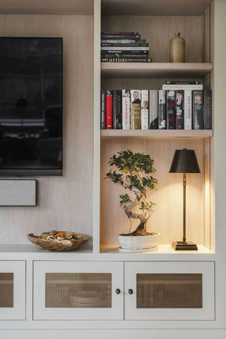 an entertainment center with bookshelves and a television mounted on it's wall