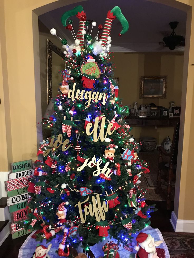 a decorated christmas tree in the middle of a living room