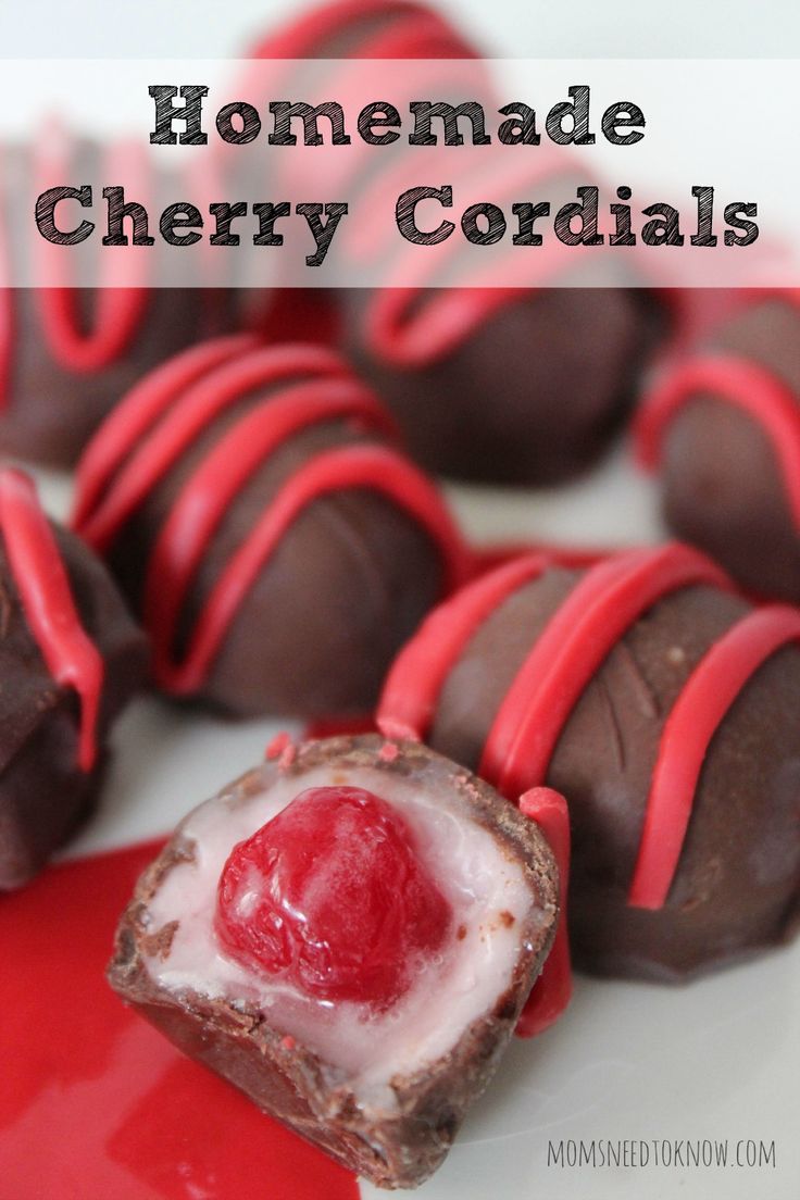 homemade cherry cordials on a white plate with red liquid and chocolate candies