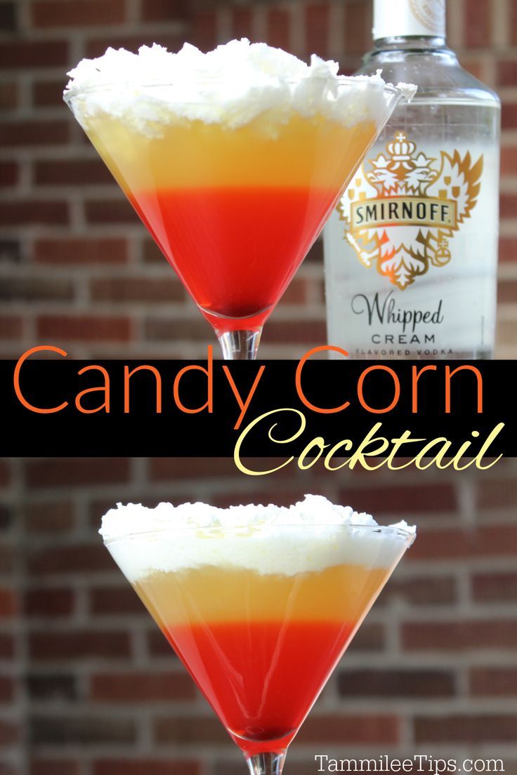 the candy corn cocktail is garnished with whipped cream and orange liquer