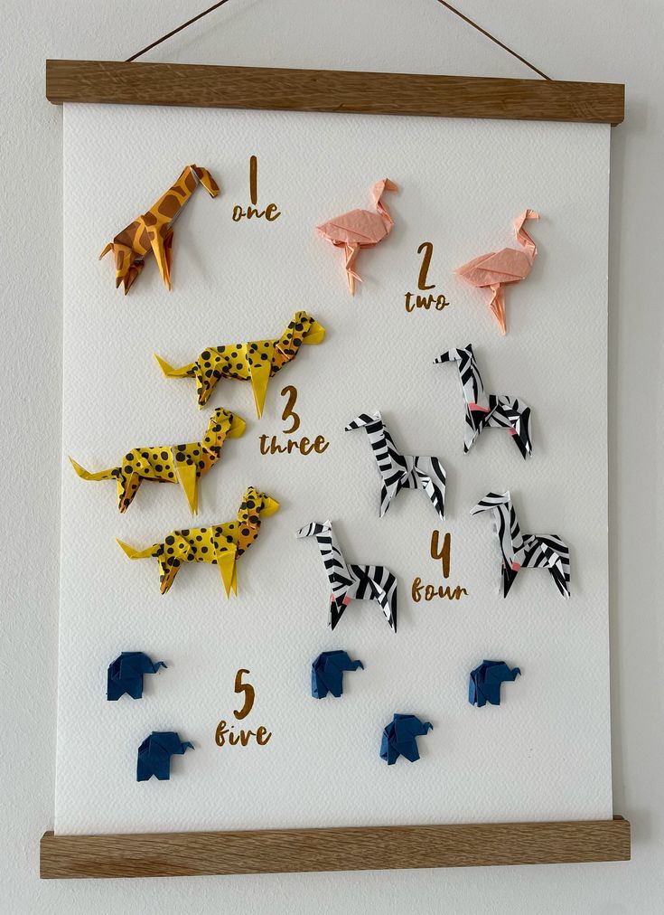 there are many different animal magnets on the wall with numbers and letters in them