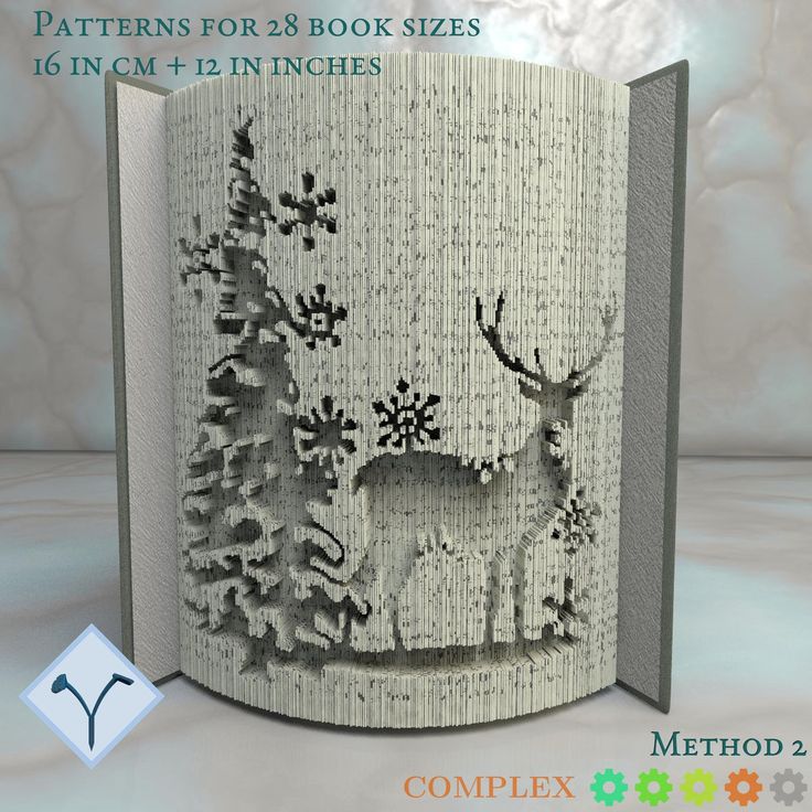 an open book with a deer and snowflakes on it