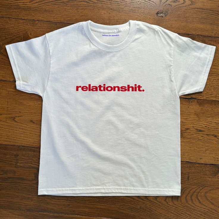 'relationshit' Baby Tee Relationshit Big Impact Baby Tee, Heavy Cotton, Iconic Slogan T-shirt, 90s Aesthetic Vintage Tee Trending Print Top  - 90's Baby tee style (made for adults) - 100% cotton - Classic fit - Runs true to size (refer to size chart) - Tear-away label - Y2K Vintage Streetwear Trending Fashion - Environmentally sustainable made-to-order system Baby tee's were popularised in the '90s, characterised by it's very short sleeves and slightly cropped body, creating a very flattering fe 90s Slogan Cotton T-shirt, 90s Style Short Sleeve T-shirt With Funny Text, Fitted Cotton T-shirt With Funny Text, 90s Style Cotton T-shirt With Letter Print, Unisex Y2k Crew Neck T-shirt, Unisex 90s Crew Neck T-shirt, 90s Short Sleeve T-shirt With Funny Text, 90s Style Cotton T-shirt With Funny Text, Y2k Crew Neck T-shirt