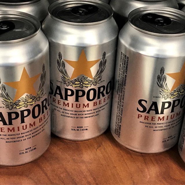 six cans of saporo premium beer on a table