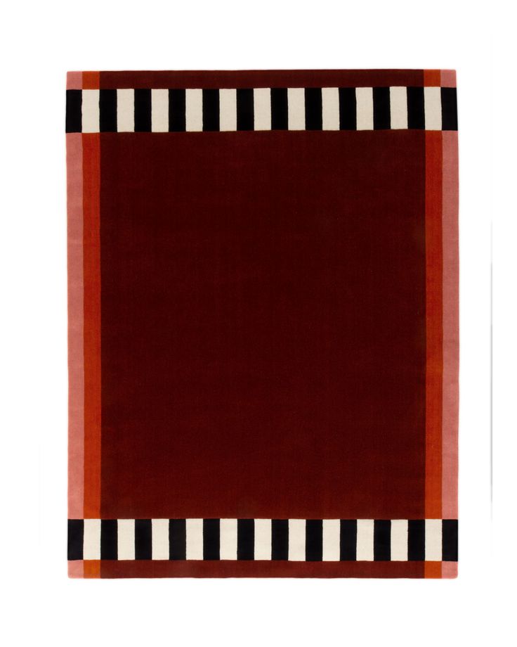 a red rug with black and white stripes on the bottom, in front of a white background