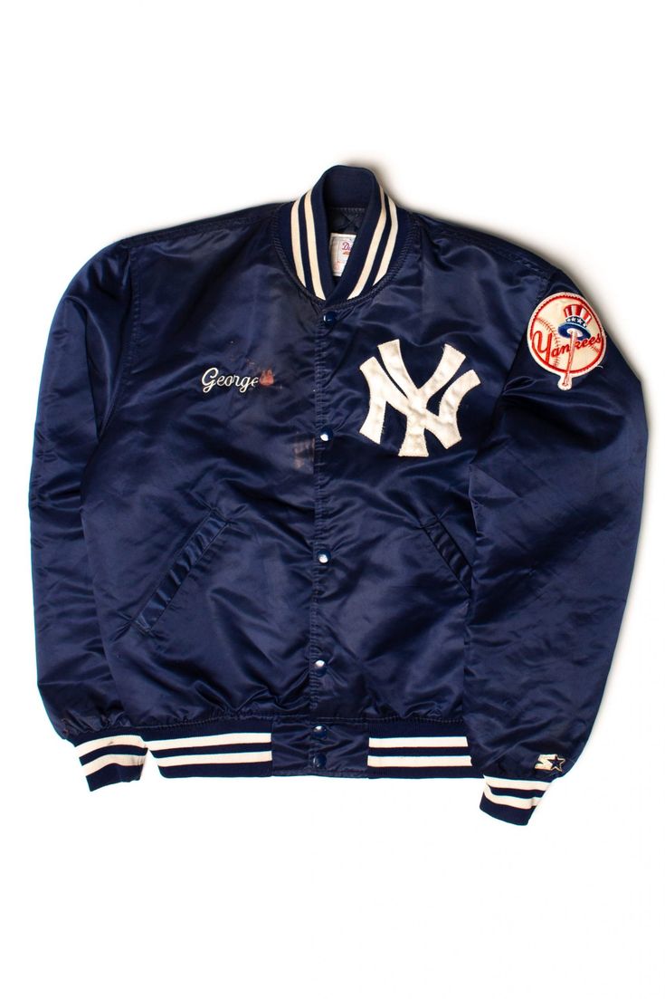 "George's Vintage New York Yankees Satin Starter Bomber Jacket (1980s) PRODUCT DETAILS: Size: Large, Brand: Starter, Color: Navy Blue, Material: Unknown, Made In: USA, Decade: 1980s, Length: 25\", Chest Width: 24\", Color: Blue All measurements are shown in inches. Measurements are taken with item laying flat. For measurements like waist and bust, which are usually measured all the way around the body, double our measurement! For example a waist measurement of 15\" (flat), is approximately a 30\ The Inheritance Games Trilogy, Nike Mid 77, Jameson Hawthorne, Jennifer Lynn Barnes, Goyard Tote Bag, The Inheritance Games, Tight Tank Top, Yankees Cap, Inheritance Games