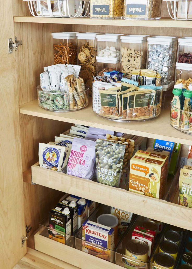 an organized pantry filled with lots of food and condiments, including cereal bars