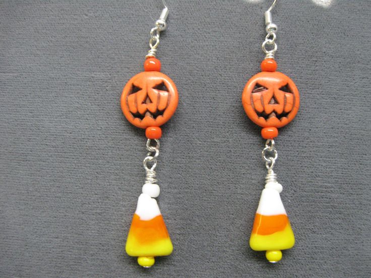 the earrings are decorated with pumpkins and candy