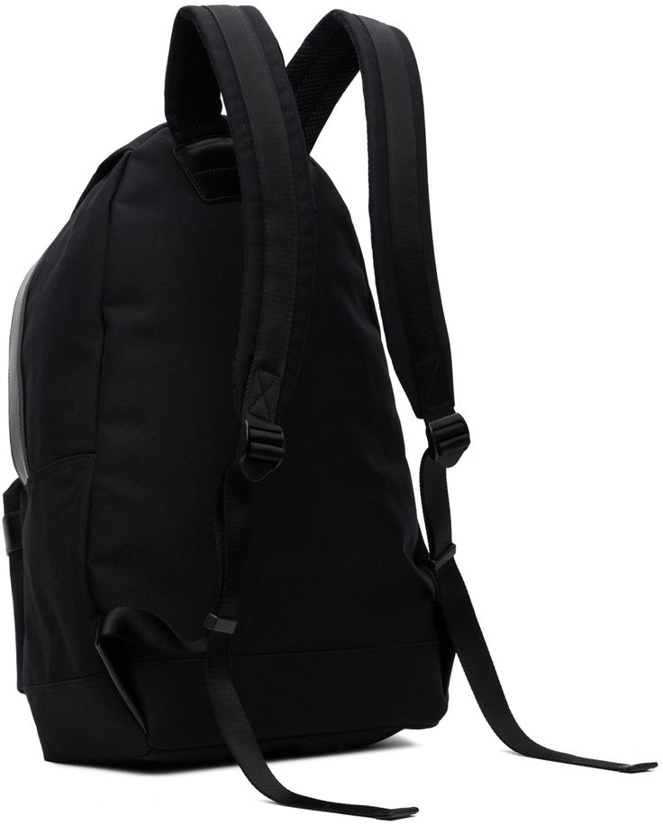 a black backpack sitting on top of a white floor