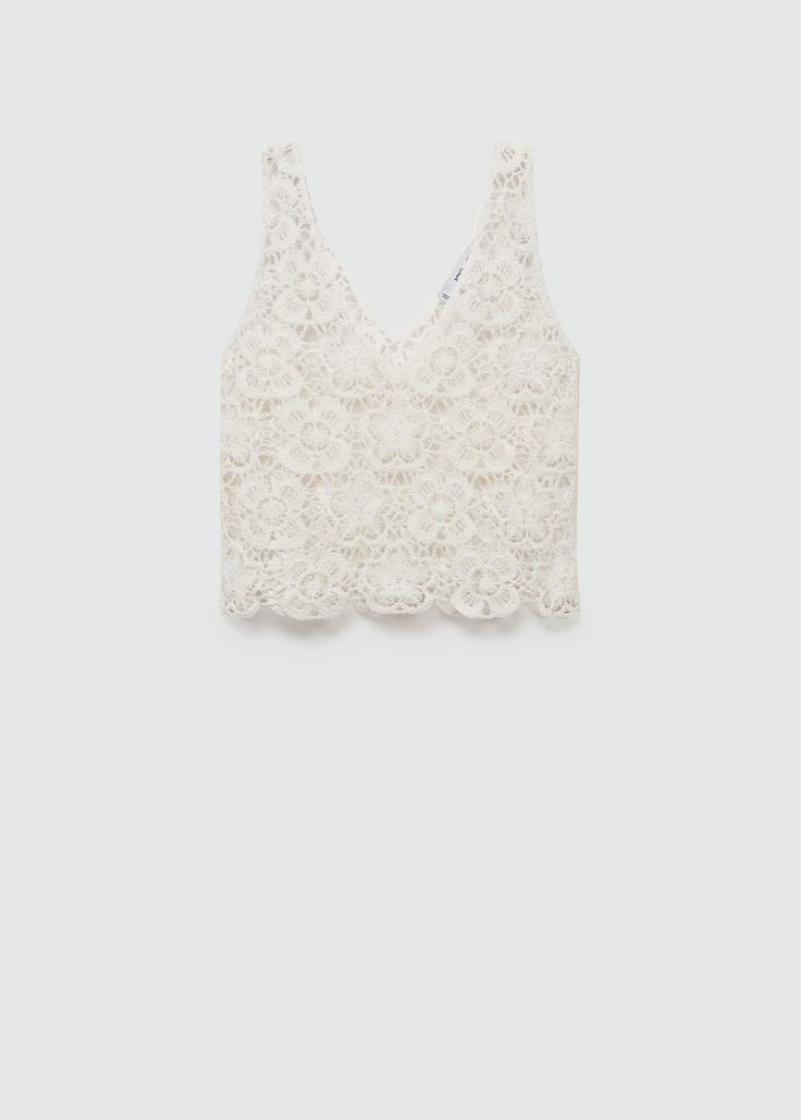 a white bra top with lace on the front and back, against a gray background