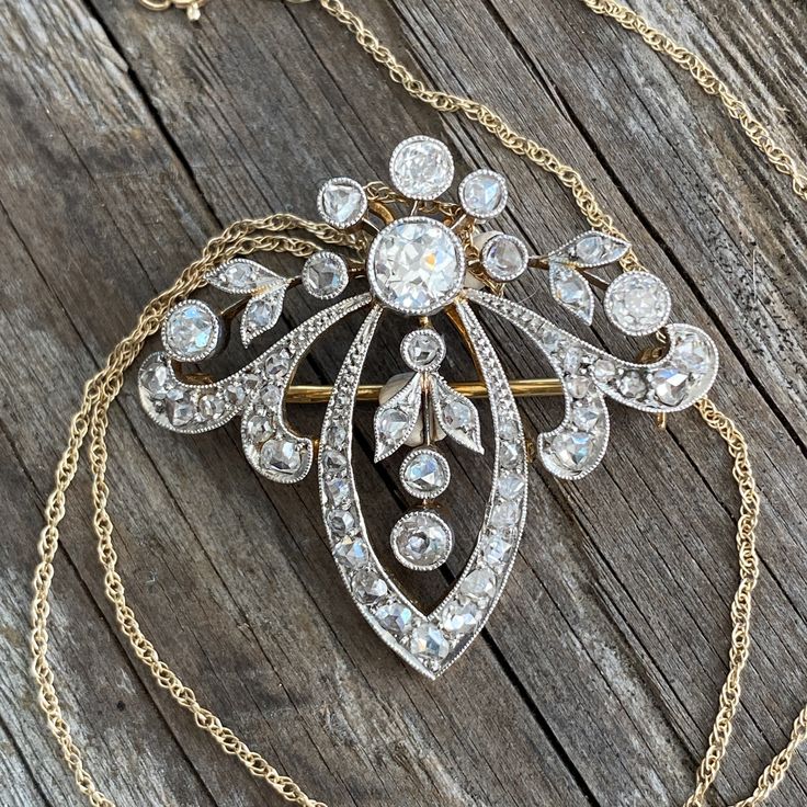 "Details: Edwardian Belle Époque diamond pendant from the early 1900's. There is a count of 50 diamonds, the largest being 5mm close to 1/2 carat. There are 5 large bezel set Old European Cut diamonds and the balance are bead set and bezel set rose cut diamonds. Mille grain work on all edges is meticulously finished. The center five diamonds move independently of the surround. A very pretty piece in excellent condition. The gold pendant tests at 18K and the 16\" modern chain is 14K gold. The pin Victorian Diamond Necklace With Single Cut Diamonds, Antique White Gold Diamond Necklace With Single Cut Diamonds, Antique White Gold Diamond Necklace, Victorian Diamond Necklace With Single Cut Diamonds For Wedding, Victorian Wedding Necklace With Single Cut Diamonds, Victorian Wedding Necklaces With Single Cut Diamonds, Victorian Diamond Necklace With Single Cut Diamonds For Formal, Vintage Single Cut Diamond White Necklace, Victorian Style Formal Diamond Necklace With Single Cut Diamonds