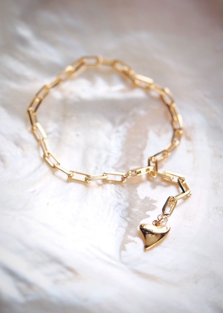 This 18kt Gold Filled Paperclip Link Chain Bracelet adds a modern element to your bracelet collection. It features the popular paper clip chain style and a vermeil shark tooth charm dangling from the end for that added statement. An on trend style and new staple. Handmade in Maui, Hawaii. ✦ DETAILS ✦ ✧ Name: Kaiea - (kaee EH ah) - rising tide. ✧ Adjustable length up to 7.5 Inches. ✧ 18kt gold filled with lobster clasp. ✧ Vermeil Shark Tooth Charm. ✧ All Ke Aloha Jewelry pieces come packaged thou Gold Charm Bracelet With Solid Links For Gift, Luxury Link Chain Bracelet As Gift, Modern Gold Plated Chain Paperclip Bracelet, Luxury Chain Bracelet With Solid Link Construction, Modern Chain Link Gold Bracelet Gift, Gold Plated Paperclip Bracelet As Gift, Gold Paperclip Chain Bracelet Gift, Gold-tone Paperclip Bracelet Chain As Gift, Gold-tone Paperclip Chain Bracelet For Gift