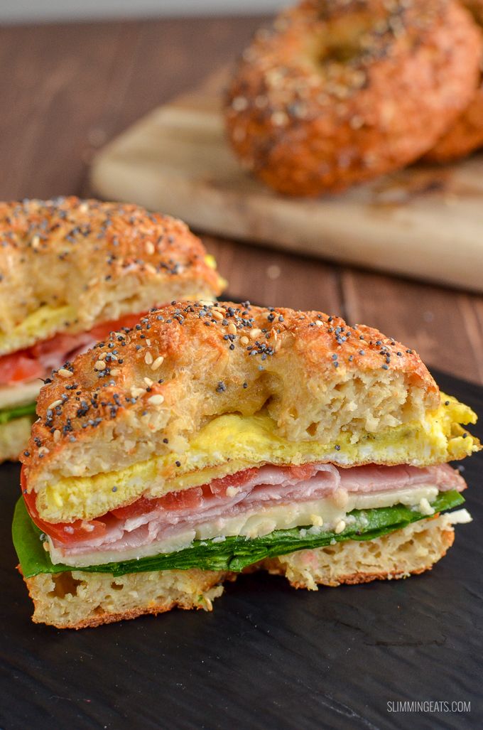 two sandwiches cut in half sitting on top of a cutting board