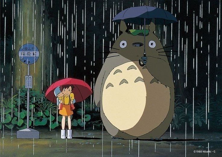 a person holding an umbrella standing in the rain with a totoro behind them