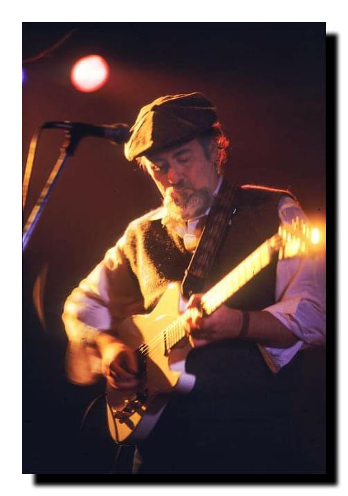 a man playing an electric guitar on stage