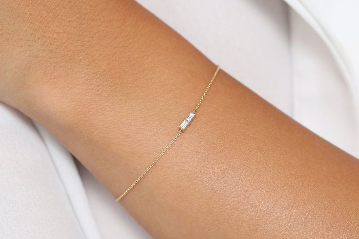 "Baguette Diamond Bracelet in 14k Solid Gold / Dainty Diamond Bracelet / Minimal Diamond Bracelet / Baguette Diamond / Black Friday Made to Order. * Gold Kt: 14K Solid Gold * Custom Gold Color: Rose Gold, Yellow Gold, White Gold * Baguette Diamond: 2 pcs 3 x 1.5 * Total Number of Stones: 2 * Total CTW: 0.12 Ctw * Diamond Color Clarity: G Color VS Clarity * Setting Type: Prong * Ready to Ship in 7-10 Business Days If you have any additional questions about this ring, just hit the \"Ask a Question Wedding Baguette Diamond Bracelet With 17 Jewels, Wedding Diamond Baguette Bracelet With 17 Jewels, Minimalist Baguette Diamond Bracelets For Formal Occasions, Minimalist Formal Bracelets With Baguette Diamonds, 14k Gold Diamond Bracelet With Baguette Diamonds For Anniversary, Rectangular Diamond Bracelet With Baguette Diamonds For Gift, Elegant 14k Gold Bracelet With Baguette Diamonds, Elegant 14k Gold Bracelets With Baguette Diamonds, Gift Rectangular Diamond Bracelet With Baguette Diamonds