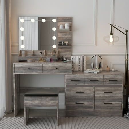 a bedroom with a vanity, mirror and lights